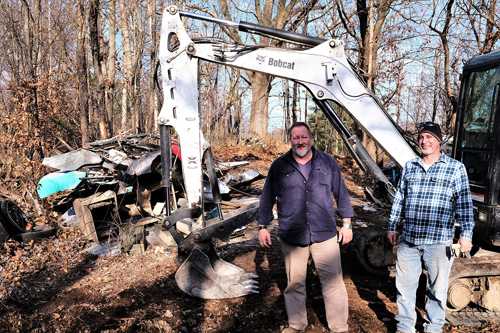 Charley Long [L] and his employee Adam Goldfish recently volunteered to clean up a portion of town property that borders the Hudson Valley Rail Trail.